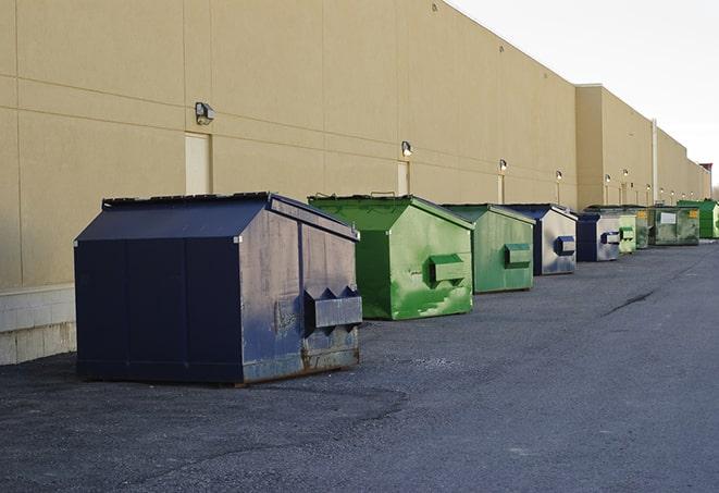 a fleet of red and blue construction dumpsters available for use in Homosassa FL